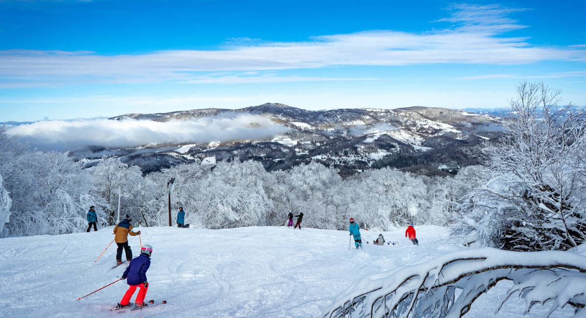 Skiers on a snow-covered slope in the North Carolina High Country